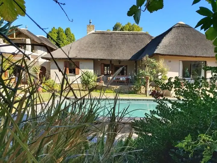 Poolside Thatch Home — thatch roofing project by Thatch Roof Solutions